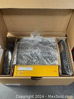 Open box showing Kodak EasyShare G610 digital camera and accessories wrapped in bubble wrap inside original box
