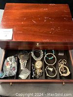 Closed wooden box with polished finish showing surface wear and marks