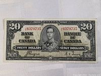 Full front view of 1937 Canadian twenty dollar Bank of Canada note showing portrait of King George VI and denomination details.