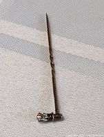Full length view of the antique cane-themed pin, showing twisted 10K gold shaft and diamond on handle.