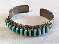 Front view of the sterling silver cuff bracelet with turquoise stones and deep patina.