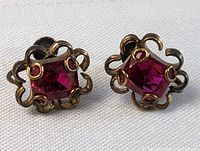 Pair of vintage ruby twist-on earrings side by side to show size and condition.