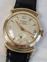 Front view of vintage Continental Geneva men's wristwatch with visible dial and black leather strap.