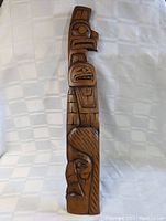 Front view of vintage Haida cedar carving with detailed Indigenous designs and smooth finish.