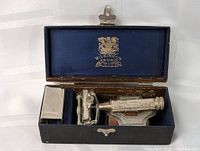 Complete razor set in open blue velvet lined Wilkinson Sword branded box showing razor components and accessories.