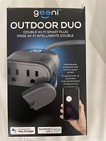 Front of the box showing product name, image of the smart plug with two outlets, Wi-Fi icons and smart assistant compatibility.