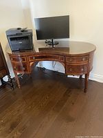 Front view of desk with printer and monitor on top