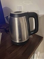 Photo of T-fal stainless steel electric kettle on countertop showing the item in good condition, handle, and base visible.