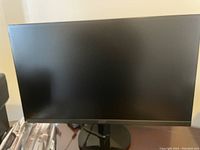 Front view of Acer 27-inch monitor showing screen and black bezels on a table.