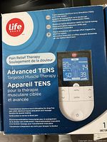 Photo of the product box showing Life Brand Advanced TENS device for pain relief therapy and targeted muscle therapy.