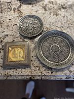 Overview of the three items: 5-inch ashtray and two decorative plates (6 and 8 inches) on countertop