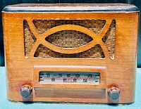 Front view of the 1946 Astra tube radio showing the wooden grille design, frequency dial, and tuning knobs.
