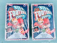 Photo showing two sealed 1991 Upper Deck Premier Edition NFL football card boxes side by side.