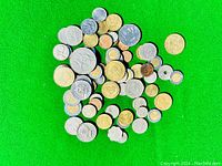 Photo showing the full assortment of coins laid on green background