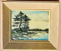 Frontal view of the small oil painting on board inside its frame, showing the lakeside landscape and signature.