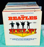 Stack of vinyl records with The Beatles’ Help! LP at front