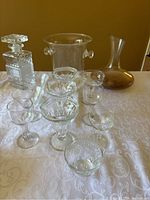 Full lot showing decanters, glasses, and ice bucket arranged on table.