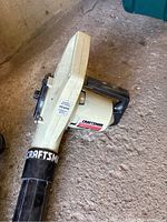 Photo of the main electric blower unit, off-white body with black handle and Craftsman label, showing side profile and branding details.