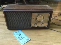 Full view of the wooden cased Zenith Model M730 radio showing speaker grille and dial with tuning cable visible.