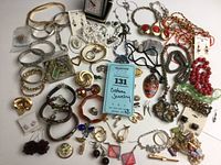 Full view of assorted vintage costume jewelry including bracelets, brooches, earrings, necklaces, and pins displayed together