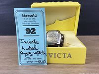 Invicta Lupah watch displayed in yellow Invicta box with hand-written lot tag