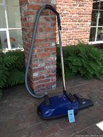 Full view of assembled canister vacuum with hose and wand attached