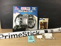 Full lot overview including 2 pairs Snow Trax, PrimeStick, Ice Trekkers package, sunglasses, AirFly Duo, and earbuds.
