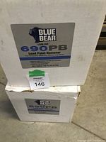 Photo showing two stacked white one-gallon containers of Blue Bear 690PB Lead Paint Remover with label details and condition.