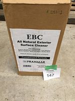 Photo of large cardboard box labeled EBC All Natural Exterior Surface Cleaner Concentrated Formula by Franmar, showing product name, uses, and natural pineapple-derived cleaner information.