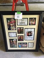 Full front view of black multi-opening picture frame with 10 photo slots filled with sample photos.