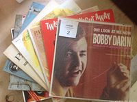 Several older vinyl record albums including Bobby Darin's "Oh! Look At Me Now" with a close-up of the album covers fanned out