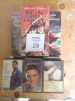 Photo of stacked VHS tapes including 'My Fair Lady' and other music-related titles.
