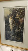 Close-up of the framed print showing the cat artwork and signature/edition details.