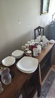 Full view of all items on table including mugs, plates, bowls, and serving pieces