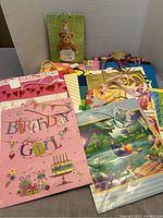 Top view showing several colorful gift bags including Birthday Girl themed bags with heart designs and ribbons
