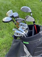 Top view of various golf clubs in the bag showing irons and woods
