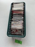 Top-down view of green basket filled with hockey sports cards stacked vertically.