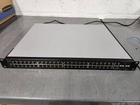 Front view of the Cisco SG500-52P switch showing all 52 ports with status LEDs.
