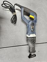 Side view of the Chicago Electric corded sawsall showing the complete tool with attached power cord and blade.