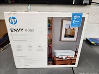 Front of the HP Envy 6055 box showing the product image, brand logo, and product name with the label for 2 months Instant Ink included.