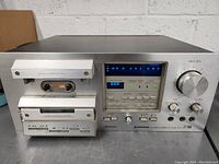 Overall view showing the full front panel of the Pioneer CT-F950 cassette deck with both tape compartments, LED display, and control knobs visible.