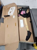 PS2 Frontman guitar controller in box with packaging foam and strap visible