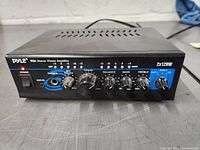 Front view of Pyle PTA4 stereo power amplifier showing control knobs, input jacks, power LED, and branding