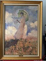 Front view of framed painting depicting a woman with parasol in impressionist style