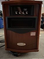 Front view of portable electric infrared heater with wood grain finish and control panel.
