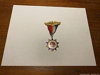 Front view of gold-toned WWII commemorative medal badge on red, white, and blue ribbon with eagle-shaped pin bar.