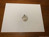 Morgan silver dollar coin pendant showing reverse eagle side page view