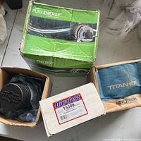 New Pure Energy alternator in green box, black part visible partially inside.