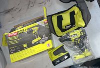 Photo showing Ryobi 18V 2-speed drill/driver kit including the drill, two batteries, Ryobi carry bag, and original box.