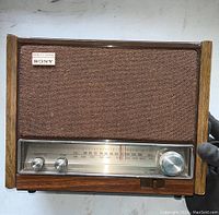 Front view of vintage Sony ICF-9640W AM/FM radio showing wooden frame, front speaker cloth, tuning scale and control knobs.